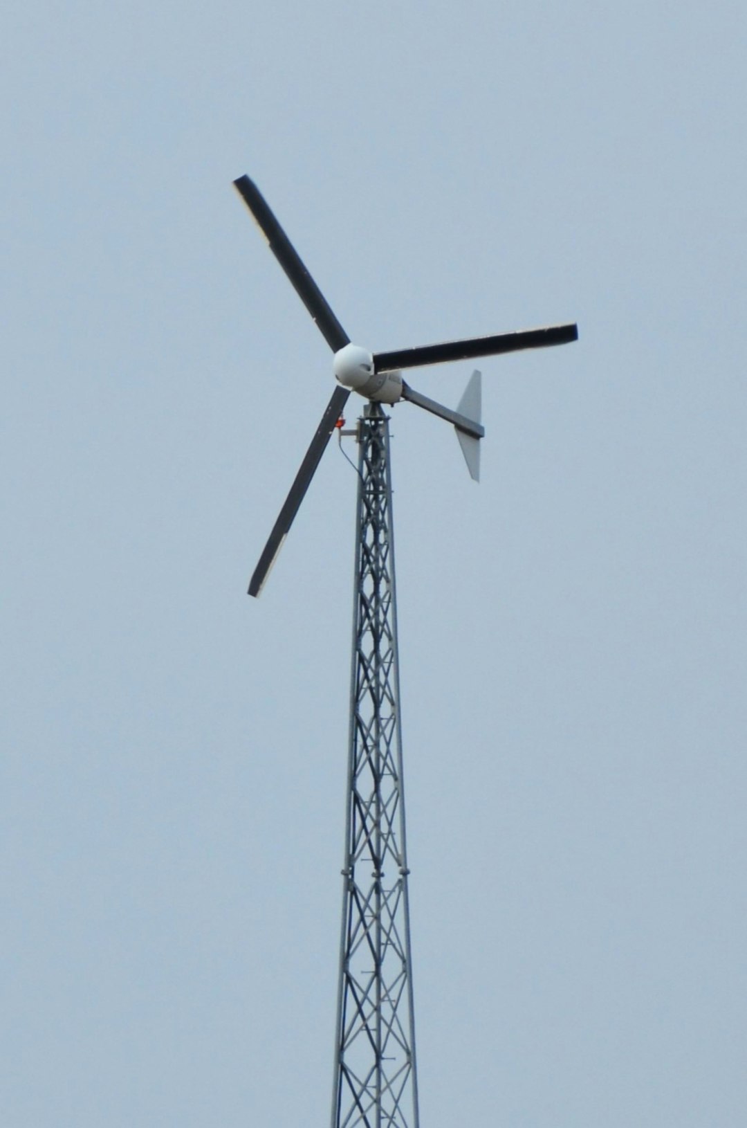 contact-hero a-wind-turbine-stands-tall-against-a-clear-sky-3qwho1ljtis